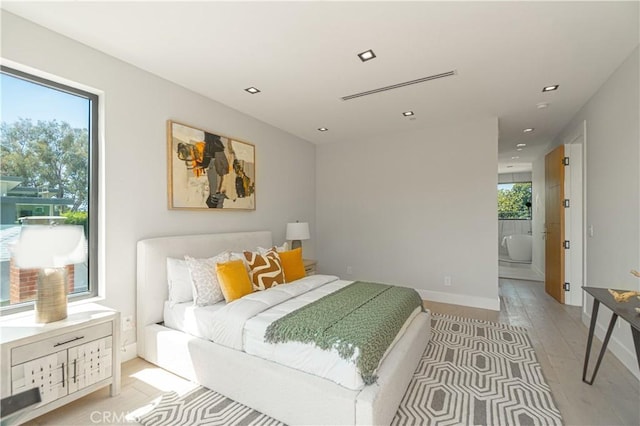 10943 Pickford Way, Culver City, CA 90230 - bedroom featuring light wood-style floors, recessed lighting, connected bathroom, and baseboards