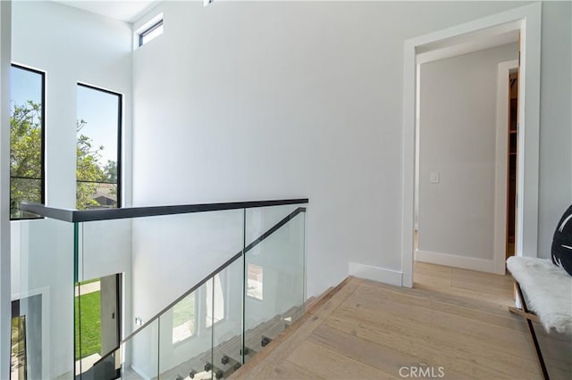 10943 Pickford Way, Culver City, CA 90230 - corridor with baseboards, an upstairs landing, and wood finished floors