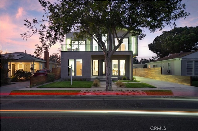 10943 Pickford Way, Culver City, CA 90230 - view of front of property with stucco siding, a balcony, and fence