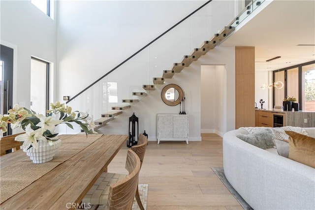 10943 Pickford Way, Culver City, CA 90230 - interior space featuring wine cooler, baseboards, an inviting chandelier, stairs, and light wood-style flooring