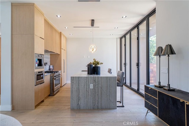 10943 Pickford Way, Culver City, CA 90230 - kitchen with appliances with stainless steel finishes, modern cabinets, expansive windows, light wood finished floors, and light brown cabinets