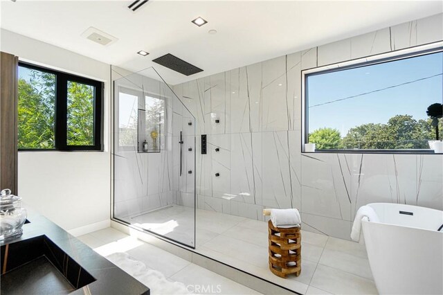 10943 Pickford Way, Culver City, CA 90230 - full bathroom with a marble finish shower, tile patterned flooring, and a soaking tub