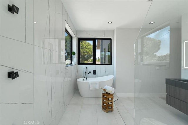 10943 Pickford Way, Culver City, CA 90230 - bathroom featuring vanity, tile patterned flooring, a soaking tub, and tile walls