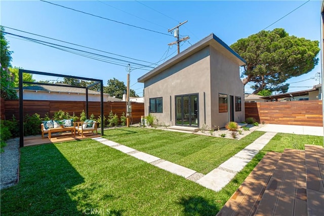 10943 Pickford Way, Culver City, CA 90230 - rear view of house featuring an outdoor living space, a fenced backyard, a patio area, and stucco siding