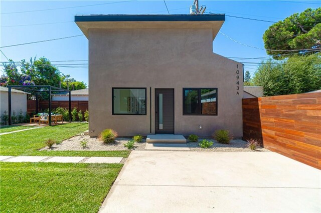 10943 Pickford Way, Culver City, CA 90230 - view of front of property with a patio, fence, a front lawn, and stucco siding