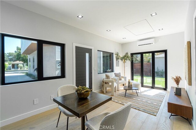 10943 Pickford Way, Culver City, CA 90230 - interior space featuring an AC wall unit, recessed lighting, light wood-style flooring, and baseboards