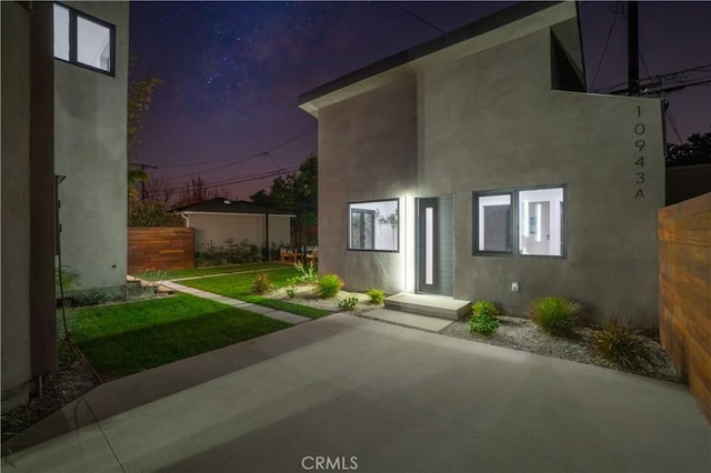 10943 Pickford Way, Culver City, CA 90230 - view of front facade featuring stucco siding, a patio area, and a front lawn