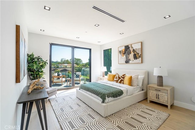 10943 Pickford Way, Culver City, CA 90230 - bedroom featuring baseboards, light wood-style flooring, and access to exterior