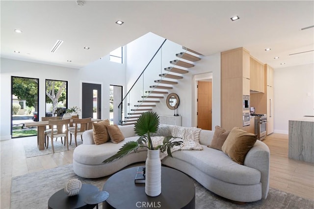 10943 Pickford Way, Culver City, CA 90230 - living area with stairs, recessed lighting, baseboards, and light wood-style flooring