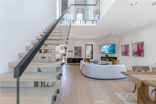 10943 Pickford Way, Culver City, CA 90230 - stairs featuring wood-type flooring, recessed lighting, and a towering ceiling