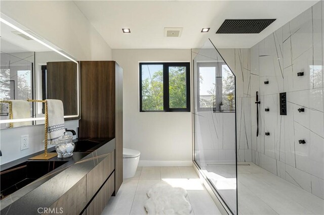 10943 Pickford Way, Culver City, CA 90230 - bathroom featuring a walk in shower, vanity, toilet, tile patterned floors, and baseboards