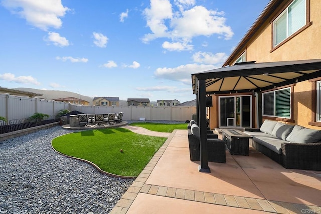 view of patio / terrace with a gazebo, a fenced backyard, and an outdoor hangout area