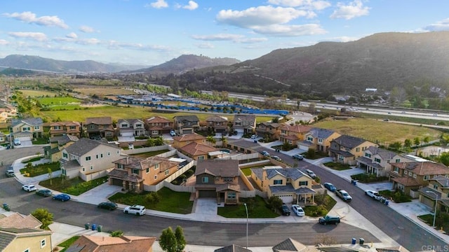 birds eye view of property featuring a mountain view and a residential view