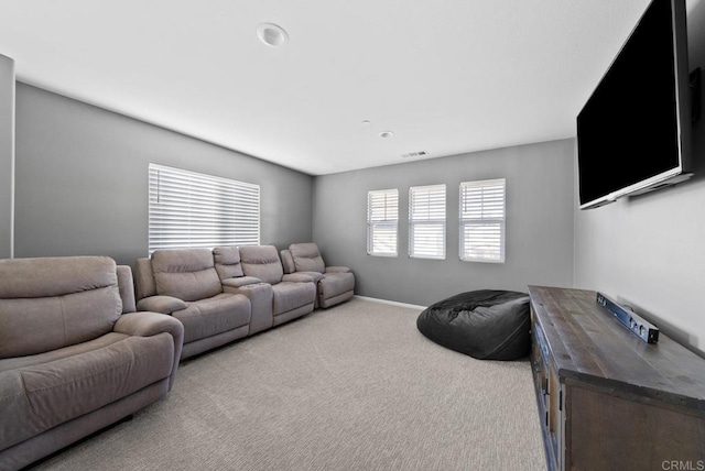 carpeted living room featuring visible vents and baseboards