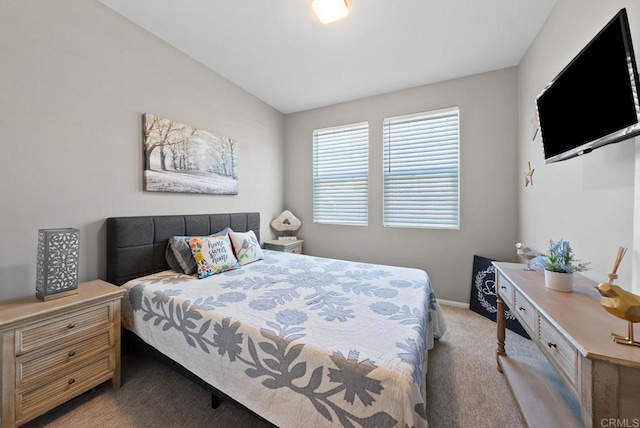 bedroom featuring light carpet, lofted ceiling, and baseboards