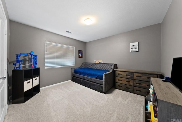 carpeted bedroom with visible vents and baseboards