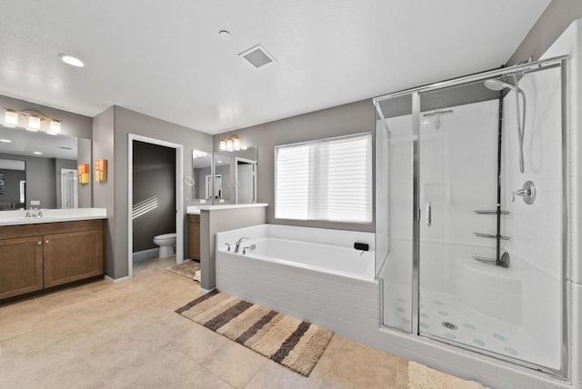 full bath with visible vents, toilet, a stall shower, a bath, and vanity