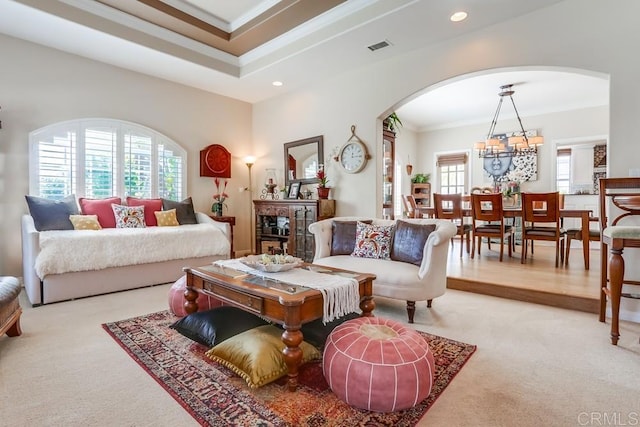 living area featuring recessed lighting, arched walkways, carpet, and crown molding