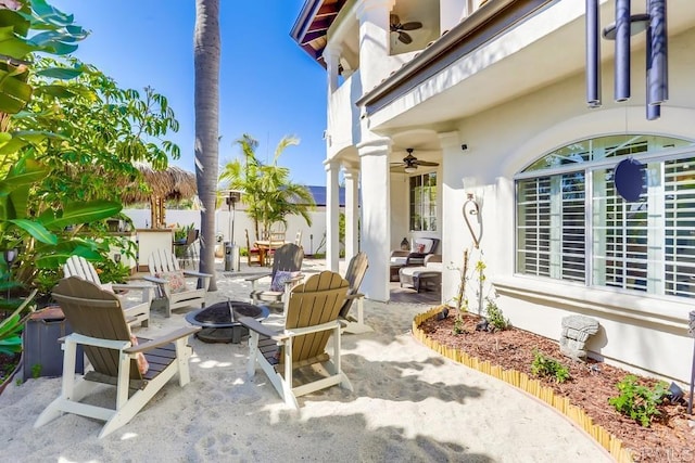 view of patio / terrace with a fire pit and ceiling fan