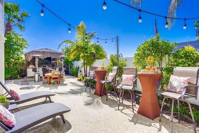 view of patio / terrace featuring a gazebo, outdoor dining area, and a fenced backyard