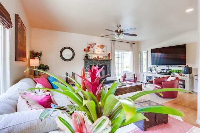 living room with recessed lighting, a ceiling fan, wood finished floors, and a fireplace