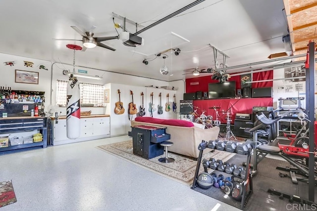 garage with a garage door opener and ceiling fan