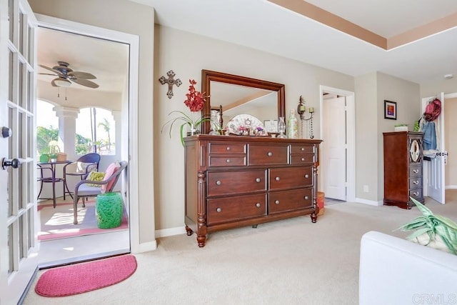 bedroom with access to exterior, light colored carpet, and baseboards