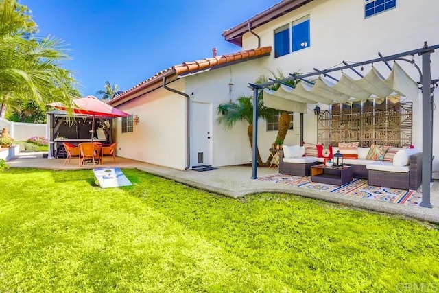 rear view of property with stucco siding, a lawn, a pergola, an outdoor living space, and a patio