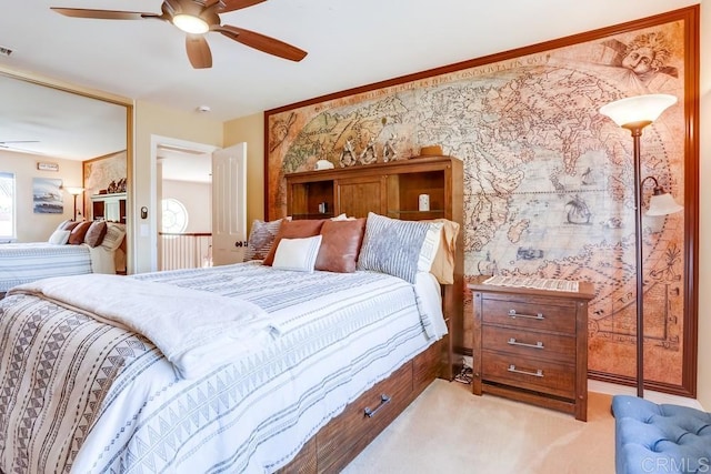 bedroom with visible vents, wallpapered walls, light colored carpet, multiple windows, and a ceiling fan