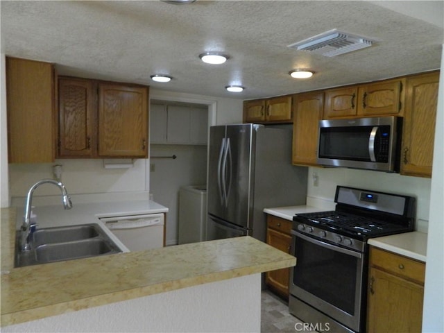 kitchen featuring light countertops, visible vents, appliances with stainless steel finishes, and a sink