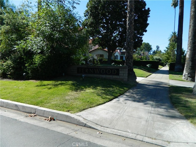 obstructed view of property featuring a front yard