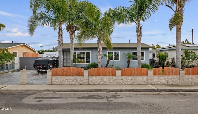 view of front of property featuring a fenced front yard and stucco siding