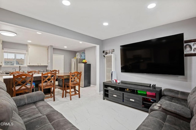 living area with recessed lighting and marble finish floor