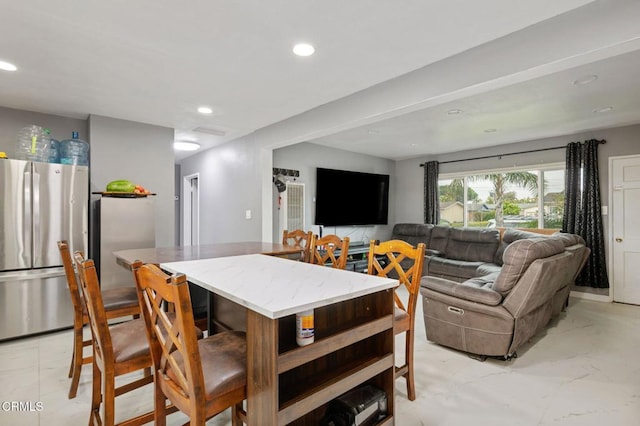 dining area with recessed lighting and marble finish floor