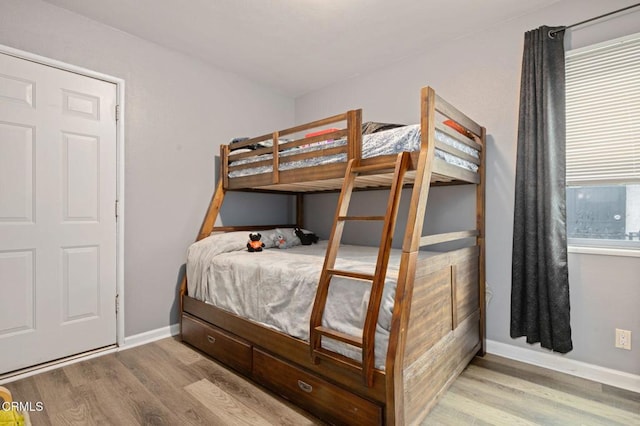 bedroom featuring wood finished floors and baseboards