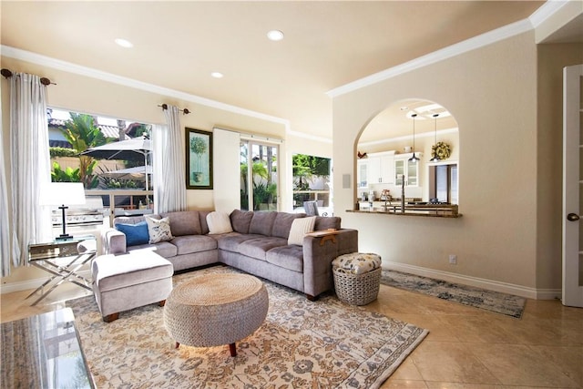 tiled living area featuring recessed lighting, baseboards, and crown molding