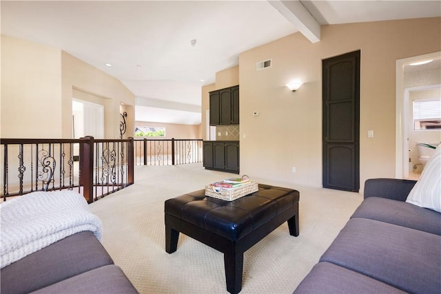 living room featuring visible vents, light carpet, and vaulted ceiling with beams