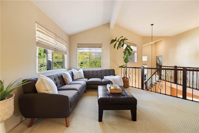 living area with carpet floors and vaulted ceiling with beams