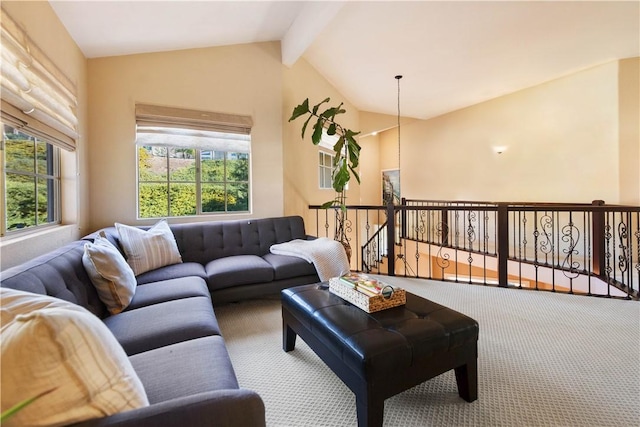 carpeted living area with vaulted ceiling with beams