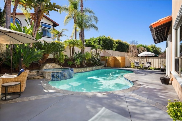 view of pool featuring a patio area, a fenced in pool, an in ground hot tub, and a fenced backyard