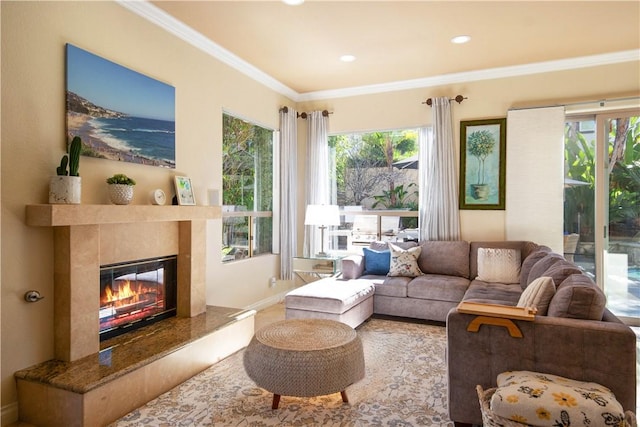 living area featuring recessed lighting, a premium fireplace, plenty of natural light, and ornamental molding