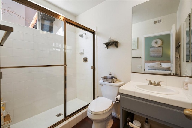 full bathroom featuring visible vents, a stall shower, toilet, and vanity