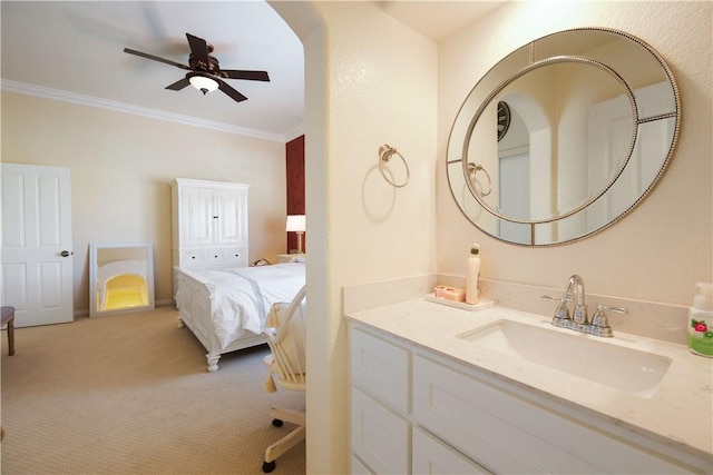 bathroom featuring vanity, crown molding, and a ceiling fan