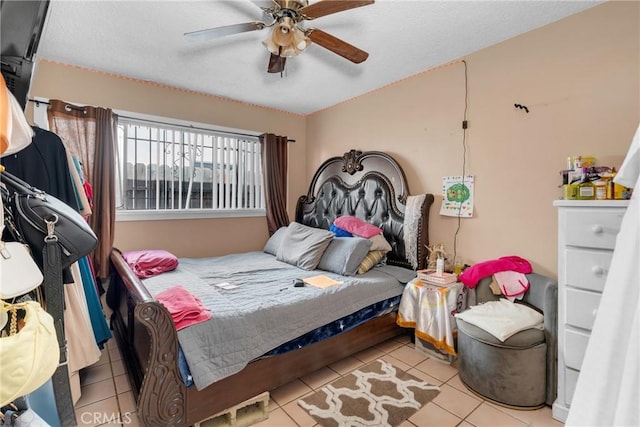 tiled bedroom featuring a textured ceiling and a ceiling fan