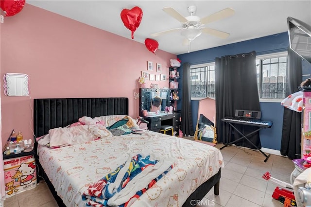 tiled bedroom with baseboards and a ceiling fan