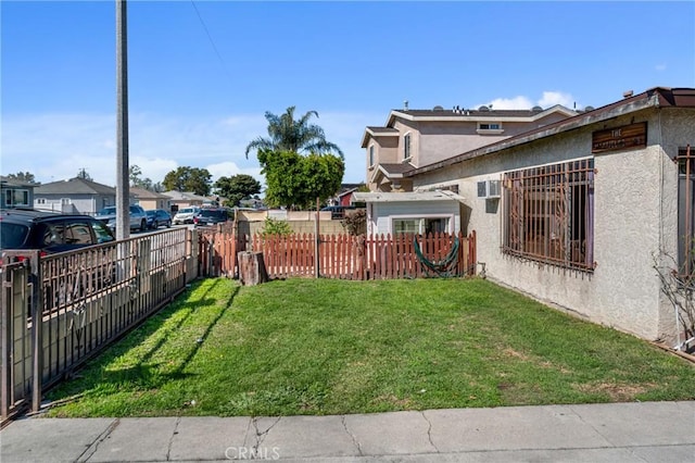 view of yard featuring fence private yard and a wall mounted AC