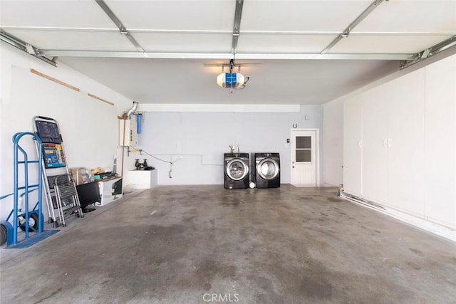 garage with a garage door opener and washing machine and clothes dryer