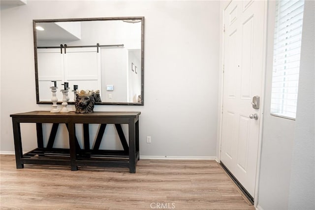 foyer featuring light wood-type flooring and baseboards