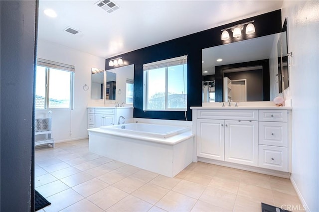 full bathroom with visible vents, a healthy amount of sunlight, and a sink