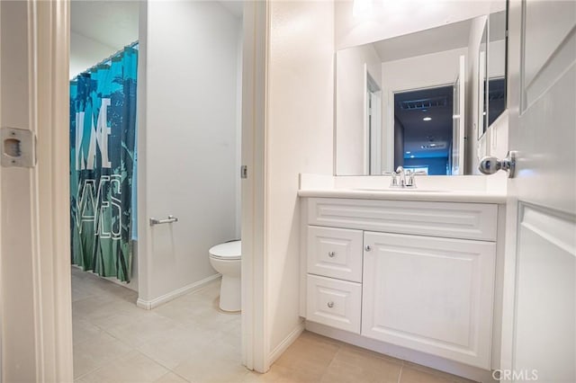 bathroom with vanity, toilet, and baseboards